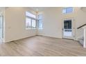 Bright and spacious living room with large windows and modern flooring at 1286 S Algonquian St, Aurora, CO 80018