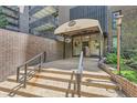 Inviting entrance to The Park Lane building with awning and well-maintained landscaping at 480 S Marion Pkwy # 1601, Denver, CO 80209
