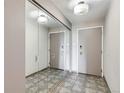 Neutral-toned hallway featuring mirrored closet doors and updated lighting at 480 S Marion Pkwy # 1601, Denver, CO 80209