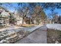 Exterior view of townhouses with snow-covered landscaping at 3445 S Ammons St # 15-4, Lakewood, CO 80227