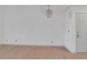 Bright entryway features wood floors, white walls and modern chandelier at 11115 E Alameda Ave # 203, Aurora, CO 80012