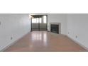 Bright living room features fireplace, sliding glass door and wood flooring at 11115 E Alameda Ave # 203, Aurora, CO 80012