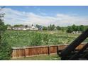 View from the back of property overlooking expansive grassy field, play area and residential homes at 4812 S Bahama Way, Aurora, CO 80015