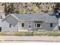 Charming home featuring a well-maintained exterior and a tidy front yard with chain link fence at 1104 Miner St, Idaho Springs, CO 80452