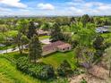 Aerial view of a property surrounded by mature trees and lush greenery in a quiet neighborhood at 2445 Vance St, Lakewood, CO 80214