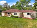 Beautifully landscaped home showcasing a lush green lawn and mature trees in a serene setting at 2445 Vance St, Lakewood, CO 80214