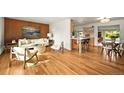Inviting living room featuring hardwood floors, modern furnishings, and an open layout with a breakfast bar at 2445 Vance St, Lakewood, CO 80214
