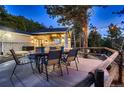 Outdoor dining area features a rustic wooden fence and string lights for ambiance at 11848 Begole Cir, Golden, CO 80403