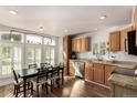 Kitchen and dining area featuring lots of windows, wood cabinets, and granite counters at 6105 Needlegrass # 307, Frederick, CO 80530