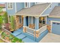 Inviting front porch featuring stone accents and space for seating, creating a welcoming entrance at 15767 E 109Th Ave, Commerce City, CO 80022