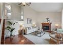 Inviting living room showcasing a fireplace, plush seating, and soaring ceilings at 12432 Bellaire St, Thornton, CO 80241