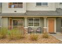 Inviting condo with a cozy front porch, perfect for relaxing, with a nice seating area at 22675 E Ontario Dr # 104, Aurora, CO 80016