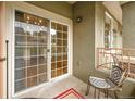Relaxing patio with seating, accessed by sliding glass doors and a view of the outdoors at 22675 E Ontario Dr # 104, Aurora, CO 80016