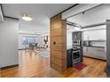 Open-concept kitchen and dining area with wood floors, modern cabinets and dining table with chairs at 1551 Larimer St # 1106, Denver, CO 80202