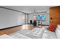 Bright living room with wood floors, city views, and a modern white leather couch at 1551 Larimer St # 1106, Denver, CO 80202