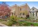 Attractive brick house featuring a lovely front yard with blooming trees and landscaping at 2330 N Emerson St, Denver, CO 80205