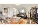 Inviting living room featuring stylish furniture, a modern coffee table, and hardwood floors with an elegant rug at 5222 Xanadu St, Denver, CO 80239