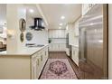 Spacious kitchen with stainless steel appliances, elegant cabinets, and decorative rug at 7255 E Quincy Ave # 404, Denver, CO 80237