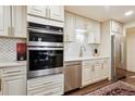 Close up of kitchen showcasing stainless steel appliances and stylish backsplash at 7255 E Quincy Ave # 404, Denver, CO 80237