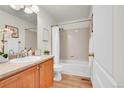 Bathroom with wood vanity, framed mirror, and shower-tub combo at 10149 W 55Th Dr # 101, Arvada, CO 80002