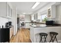 Bright kitchen with stainless steel appliances, breakfast bar, and wood-look flooring at 8746 Sunridge Hollow Rd, Parker, CO 80134