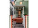 Charming front porch with covered entrance, decorative columns, and a vibrant, inviting appeal at 616 W 1St Ave, Denver, CO 80223
