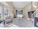 Bright living room with high ceilings, lots of natural light, a white piano and decorative chair at 730 Pope Dr, Erie, CO 80516