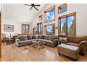 Bright living room with vaulted ceilings, large windows, hardwood floors, and comfortable seating area at 72 Overlook Ct, Idaho Springs, CO 80452