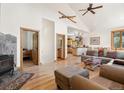 Inviting living room with hardwood floors, fireplace, and open floor plan to kitchen and dining area at 72 Overlook Ct, Idaho Springs, CO 80452
