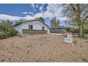 Side view of property with a gravel front yard and 'Coming Soon' sign at 12879 E Oregon Dr, Aurora, CO 80012