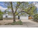 Charming single story home with attached garage, mature landscaping, and brick accents at 12879 E Oregon Dr, Aurora, CO 80012