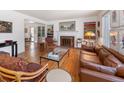 Spacious living room with hardwood floors, a fireplace, built-in shelving, and comfortable seating arrangement at 995 S Jackson St, Denver, CO 80209