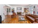 Elegant living room boasting hardwood floors, a fireplace, built-in bookcases, and comfortable seating at 995 S Jackson St, Denver, CO 80209