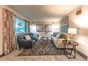 Bright and inviting living room with plush seating, stylish decor, and a large window offering ample natural light at 1583 Skeel St, Brighton, CO 80601