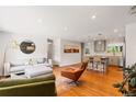 Inviting living room with hardwood floors, contemporary furnishings, and an open layout to the kitchen at 5525 E Bails Dr, Denver, CO 80222