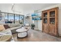 Living room with L-shaped sofa, coffee table, and large TV at 550 E 12Th Ave # 509, Denver, CO 80203