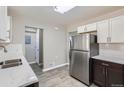 Bright kitchen featuring stainless steel appliances, a double sink, and ample counter space for meal preparation at 384 S Decatur St, Denver, CO 80219