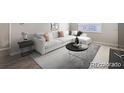 Bright living room with a large white sectional sofa, modern coffee table, and natural light from a window at 384 S Decatur St, Denver, CO 80219