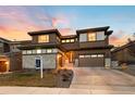 Beautiful home for sale boasting modern architecture and manicured landscaping at sunset at 16370 Graham Peak Way, Broomfield, CO 80023