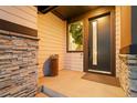 Inviting entryway featuring a modern front door with stone accents and stylish decor at 16370 Graham Peak Way, Broomfield, CO 80023
