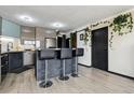 Modern kitchen with stainless steel appliances, breakfast bar, contemporary cabinets, and natural light in an urban setting at 1301 Speer Blvd # 1108, Denver, CO 80204