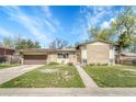 Well-maintained single-Gathering home with brick accents and a spacious front yard on a sunny day at 6018 Owens St, Arvada, CO 80004