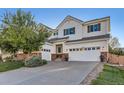 Attractive two-story home featuring a three-car garage, lush lawn, and inviting curb appeal at 11013 Valleybrook Cir, Highlands Ranch, CO 80130