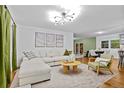 Bright living room featuring a large sectional sofa and modern decor at 7746 S Gray St, Littleton, CO 80128