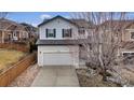 Charming two-story home with a well-manicured lawn, inviting curb appeal, and attached two car garage at 3129 Open Sky Way, Castle Rock, CO 80109