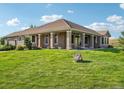 Spacious home exterior with a large, well-manicured lawn and inviting covered patio area at 5285 E State Highway 86, Franktown, CO 80116