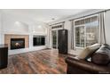 Spacious living room with hardwood floors, fireplace, and multiple windows at 1509 S Florence Ct # 218, Aurora, CO 80247