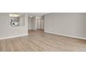 Spacious living room with wood floors, ample lighting, and an open view to the kitchen area at 14001 E Marina Dr # 603, Aurora, CO 80014