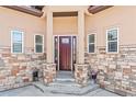Inviting front entrance with decorative stone accents and a covered porch at 6532 S Tempe St, Aurora, CO 80016