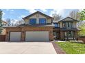 Attractive home exterior featuring a three-car garage, brick accents, and a well-kept lawn at 540 Columbine Ave, Broomfield, CO 80020